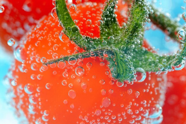 Cherry tomato closeup in water underwater macro selective focus juicy vegetable with a bubble of juice