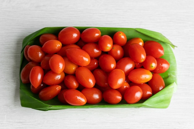 Cherry tomatoes in a banana leaf. Eco friendly packaging