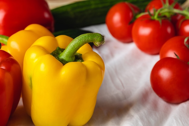 Cherry tomatoes and bell pepper on kitchen table