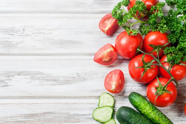 Cherry tomatoes on a branch, cucumber, parsley