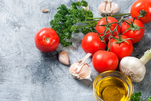 Cherry tomatoes on a branch, oil,  parsley and spice