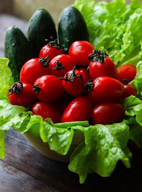 Cherry tomatoes cucumbers and green lettuce Closeup food photography