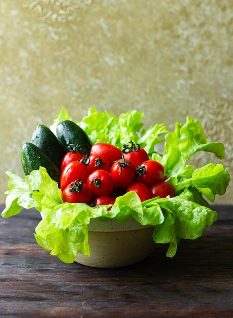 Cherry tomatoes cucumbers and lettuce leaves Food photography