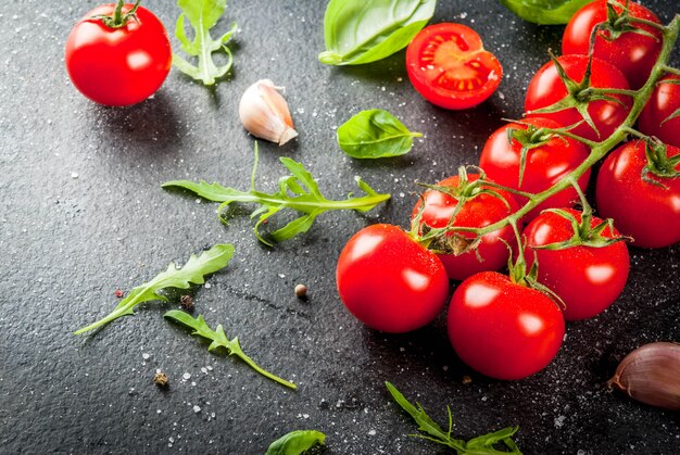 Cherry tomatoes on dark stone table