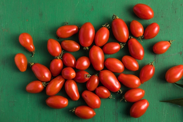 Cherry tomatoes on green table