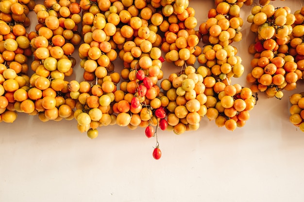 Cherry tomatoes hanging on the wall in the south of Italy