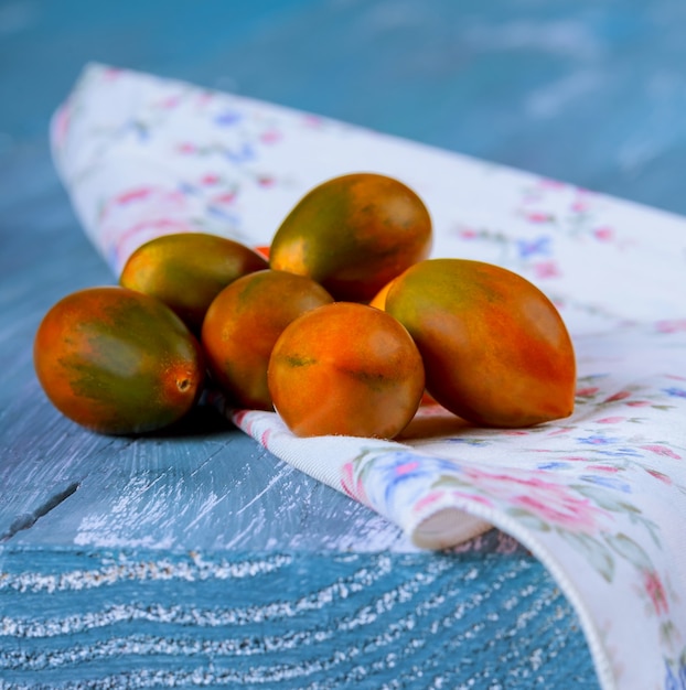 Cherry tomatoes on old turquoise wooden background