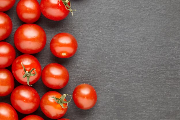 Cherry tomatoes over stone table.