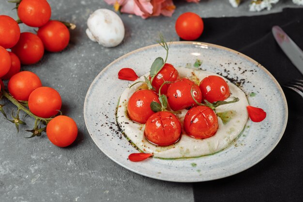 Cherry tomatoes with tofu mousse on a plate