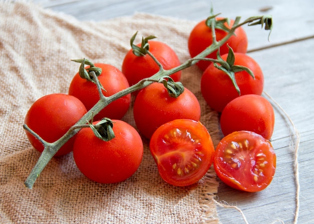 Cherry tomatos  on a wooden table close up