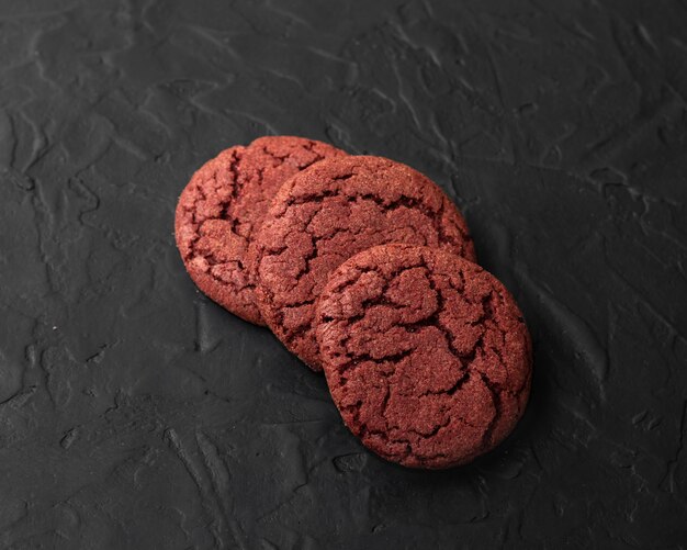 Cherry velvet cookies on a black background.