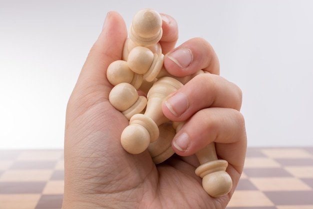 Photo chess board with chess pieces in hand