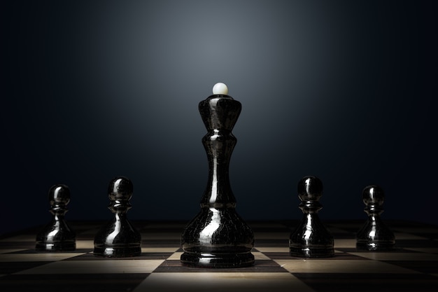 Chess board with figures on dark background close up