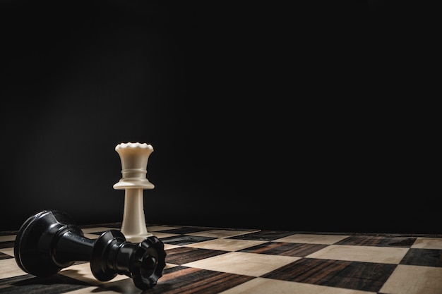 Chess board with figures on dark background macro