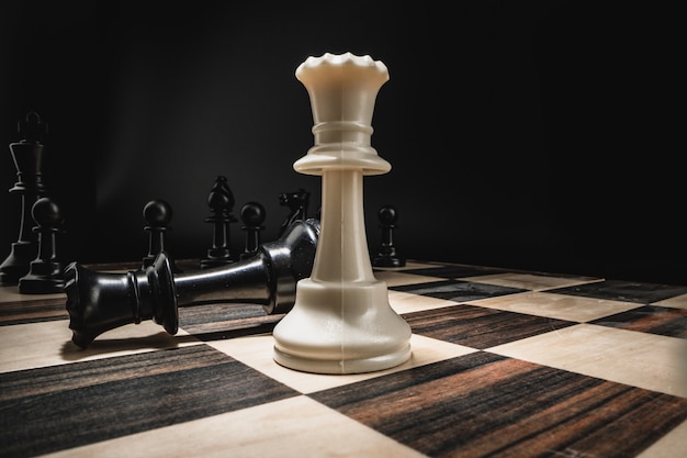 Chess board with figures on dark background