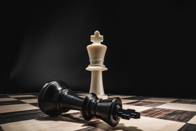 Chess board with figures on dark background