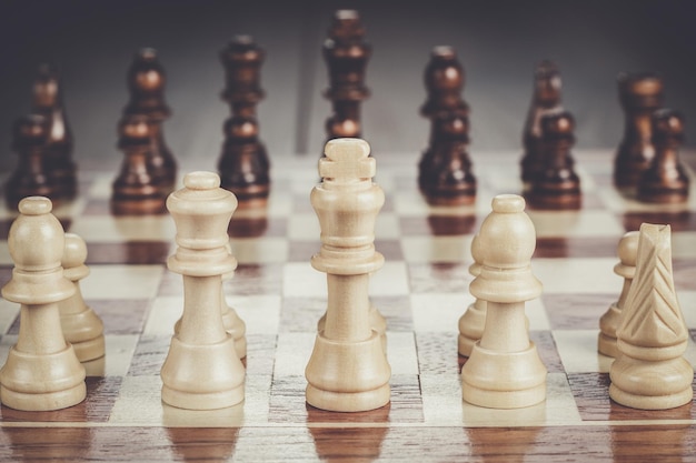 Chess board with figures on the wooden table