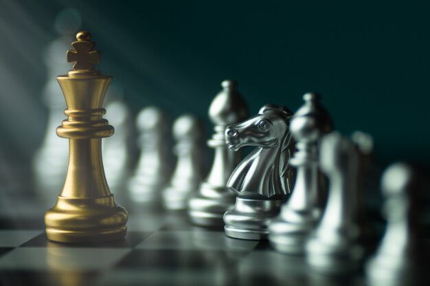 Free Photo  Gold and silver chess on chess board game for business  metaphor leadership concept