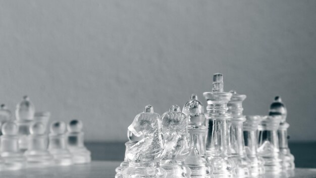 Chess game. Chess pieces made of glass. Rivalry concept.