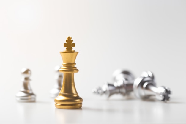 Chess game gold king standing and silver background, business strategy concept.