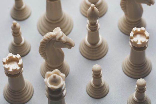 Chess game pieces on a grey background Strategy concept