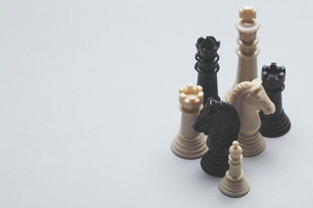 Chess game pieces on a grey background Strategy concept