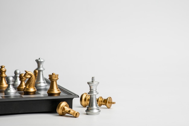 Chess leadership concept with gold and silver chess isolated in white background.