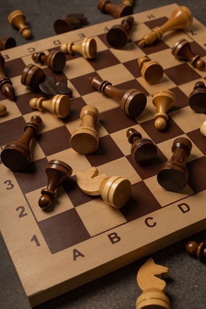 Chess pieces are scattered chaotically on a chessboard