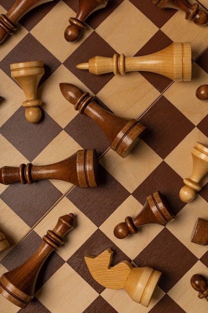 Chess pieces are scattered chaotically on a chessboard