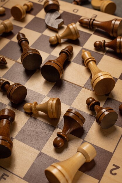 Chess pieces are scattered chaotically on a chessboard