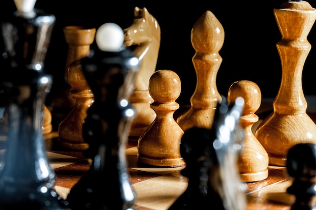 Chess pieces on a black surface