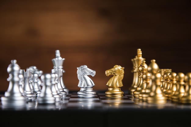 Chess pieces on the board on the table