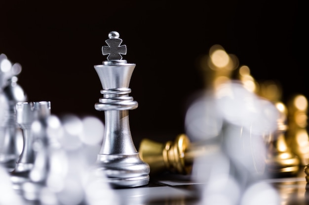 Premium Photo  Glass chess board game in black background selective focus  on king leadership concept