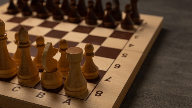 Chess pieces on a chessboard on a dark background