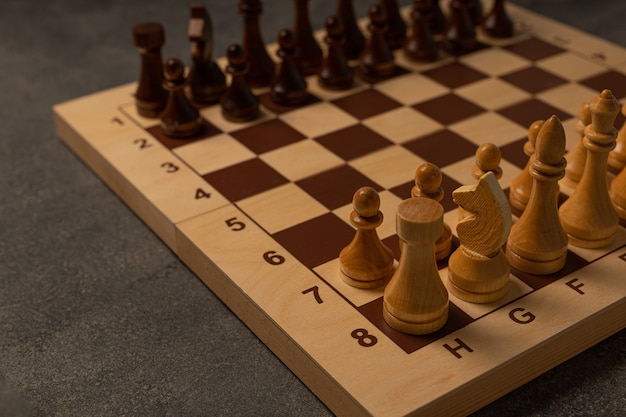 Chess pieces on a chessboard on a dark background