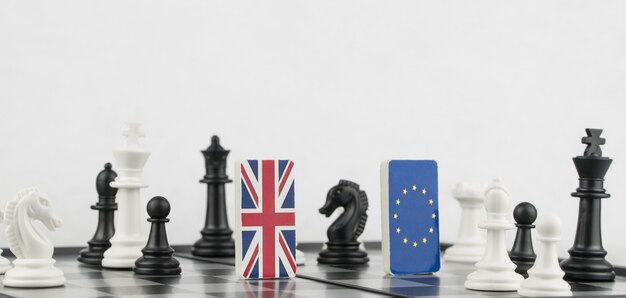 Chess pieces and flags of the European Union and the Britain on a chessboard