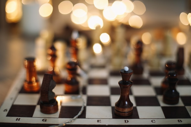 chess pieces on a wooden chess board