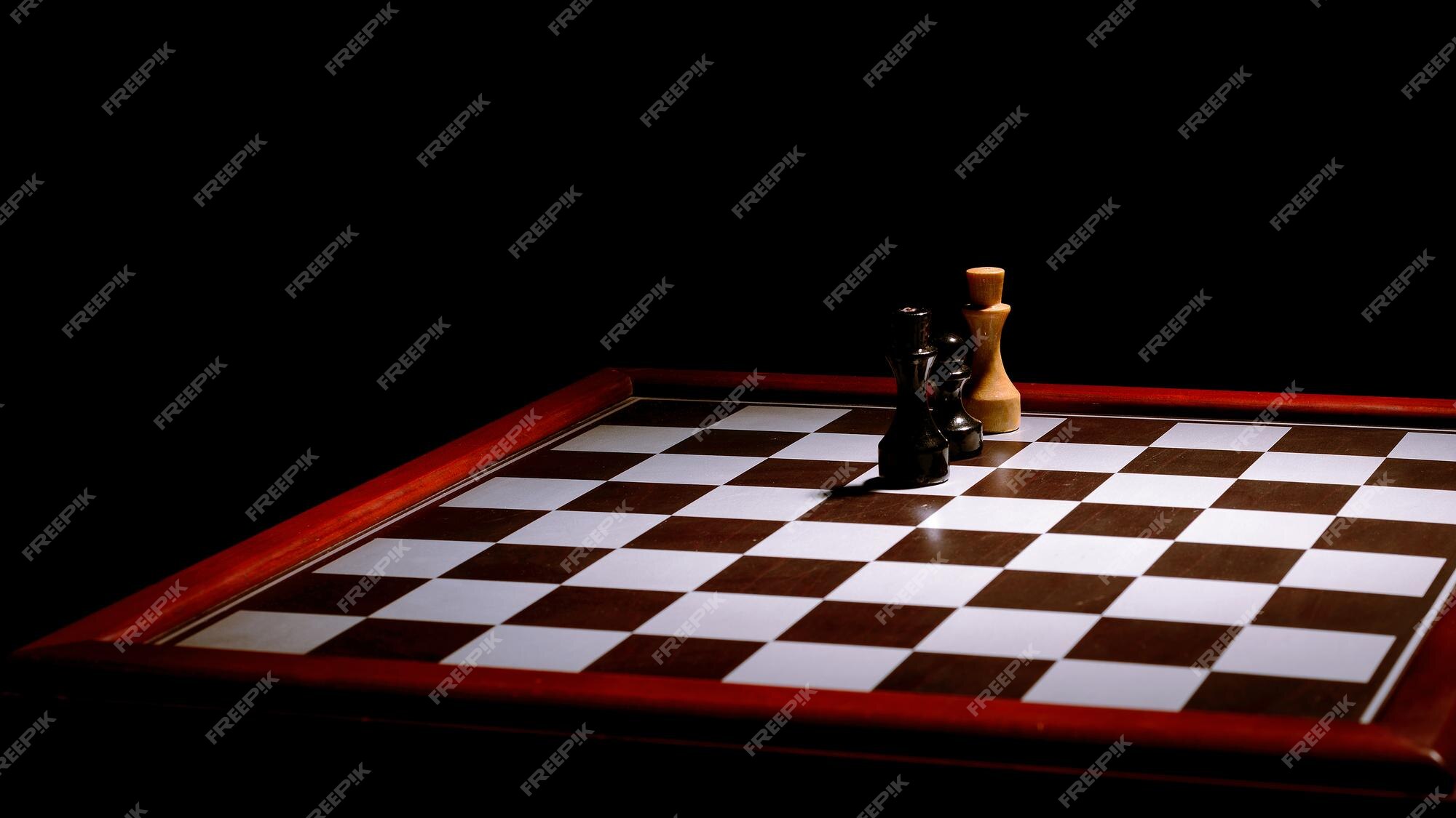 Premium Photo  Three pieces on a dark chessboard