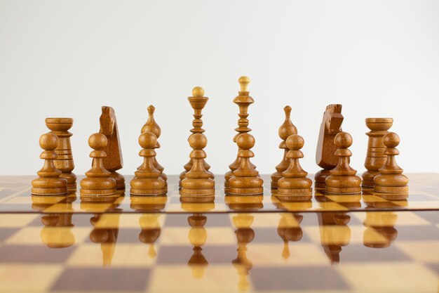 Chessboard made of wooden pieces on white