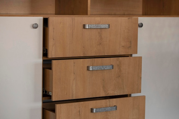 Chest of drawers in reddishbrown chipboard and white doors with silver hardware