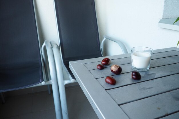 Chestnut fruits on the table Table and chairs on the balcony or terrace End of season at the hotel The table is painted silver