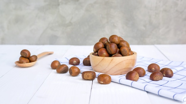 Chestnuts in a bowl on a wooden table