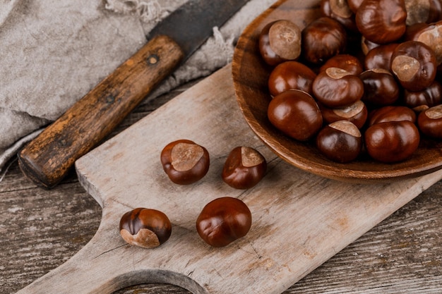 Chestnuts on an old wooden table.