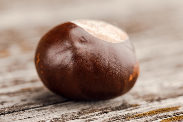 Chestnuts on an old wooden table.