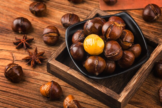 Chestnuts on a wooden background.