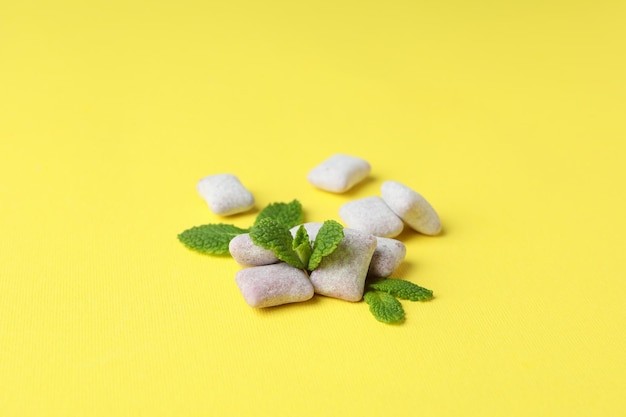 Chewing or bubble gum on yellow background