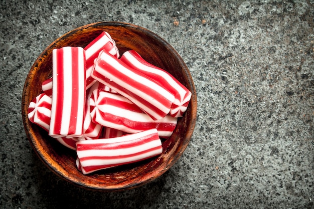 Chewing jelly in bowl. On rustic table.