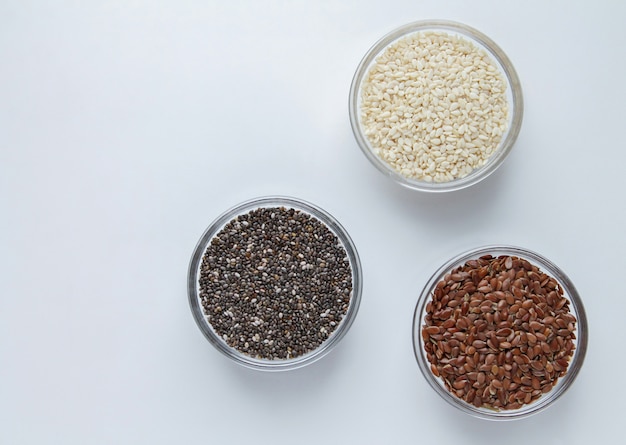 Chia, flax, sesame in glass bowls