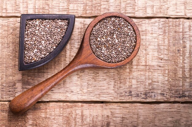 Chia grains in container on rustic wood