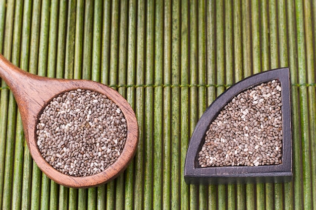 Chia grains in container on rustic wood